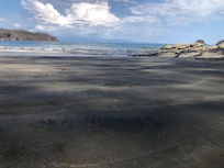 Beach with only one other couple on it.