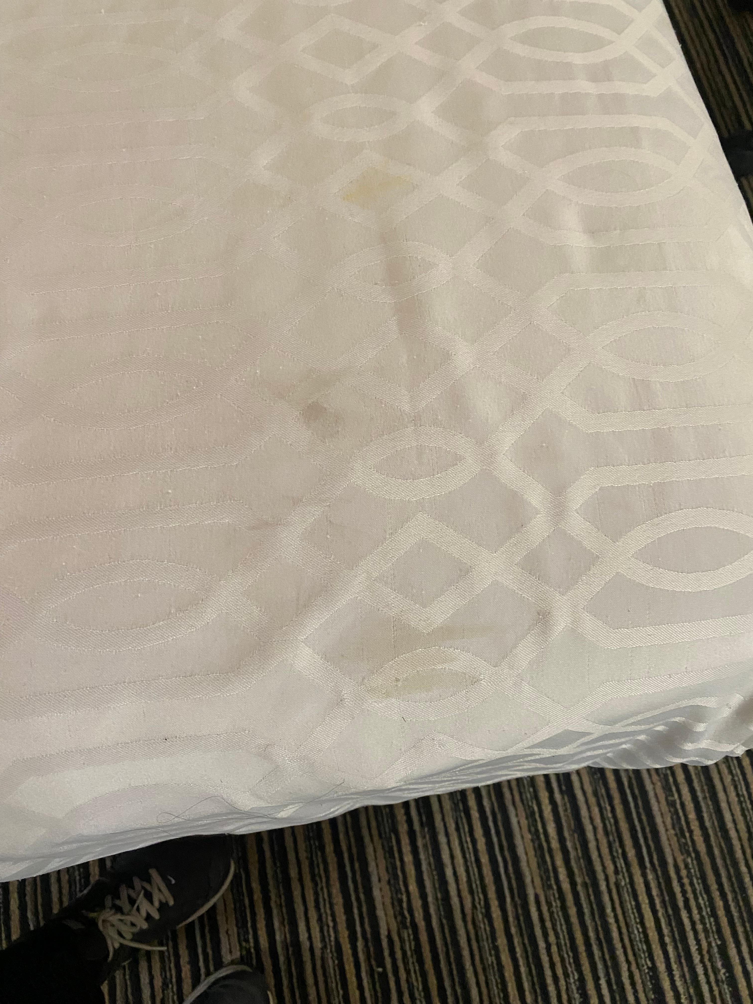 Bed spread had stains. 