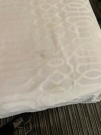 Bed spread had stains.
