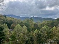 The clouds playing hide and seek with the mountain.