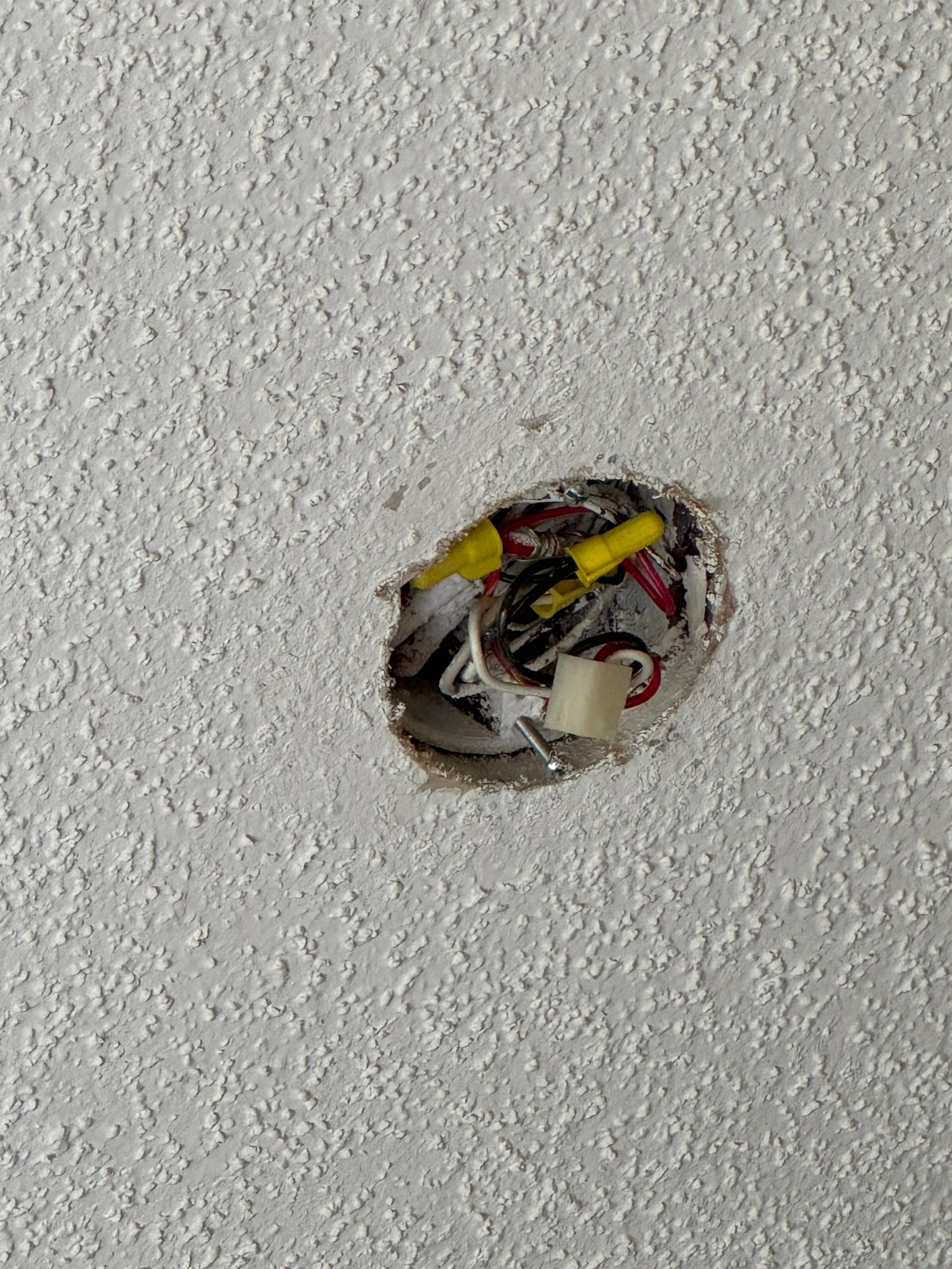 Looks like an old light fixture maybe. It was o we the bed. 