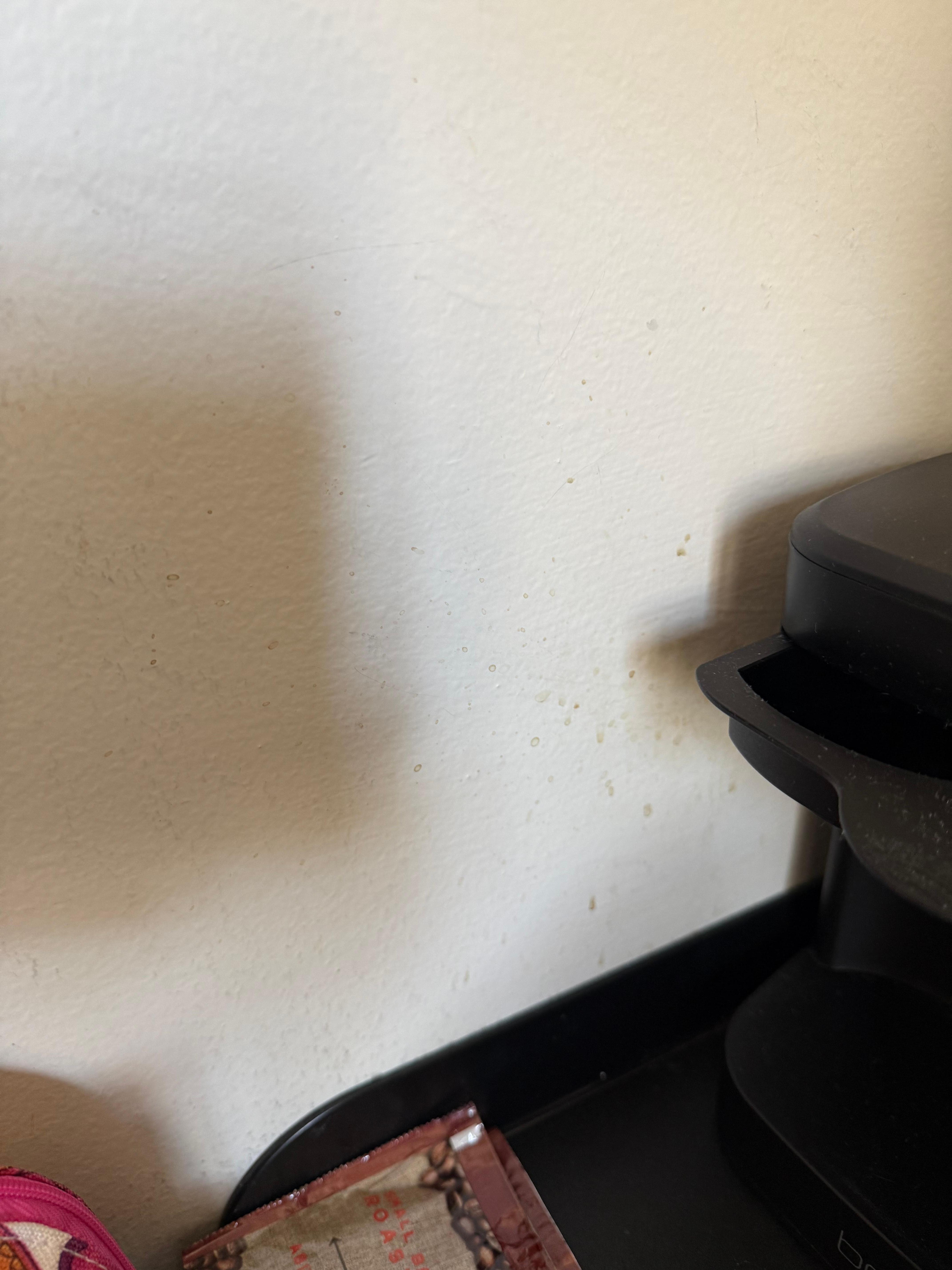 Coffee splatter on the walls next to the coffee pot, we had coffee but we didn’t have cups or any condiment packets. 