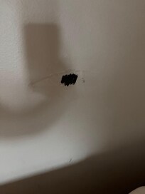 The hole in the wall they put tape over and used a black marker as if it was invisible!!