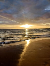 walking on charlie young beach at sunset