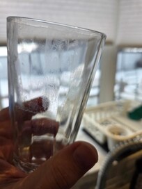 One of many dirty glasses pulled right out of the cabinet. We had to wash everything before using the. 3 total pans, but 2 were Woks that weren't helpful.