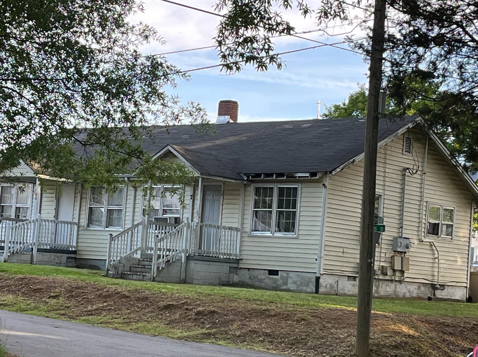 This is a house across the street. It looks like a rundown shack. There's another house next to it, very similar. I was shocked when I turned onto the street.