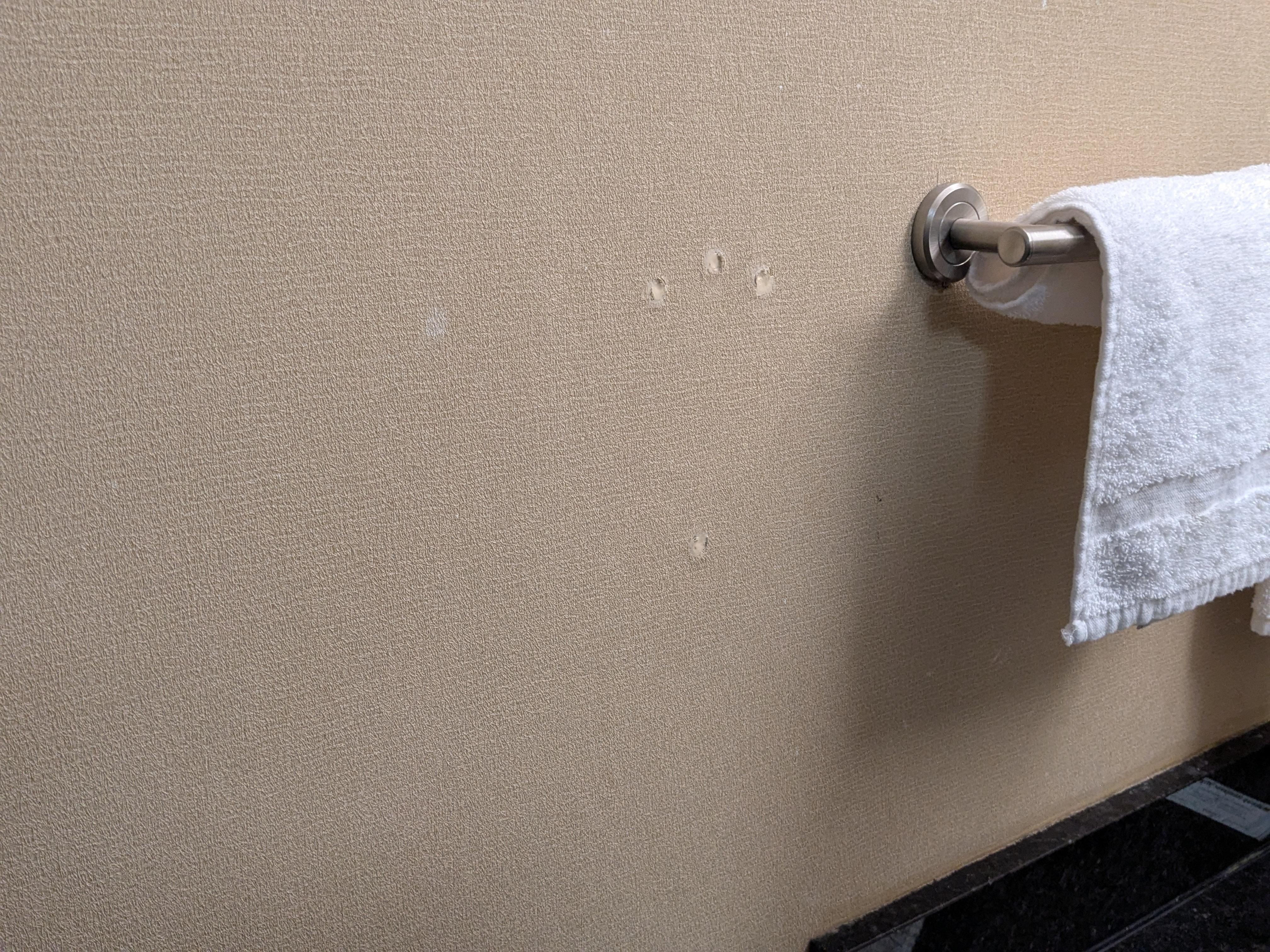 Holes in the wall filled with caulk