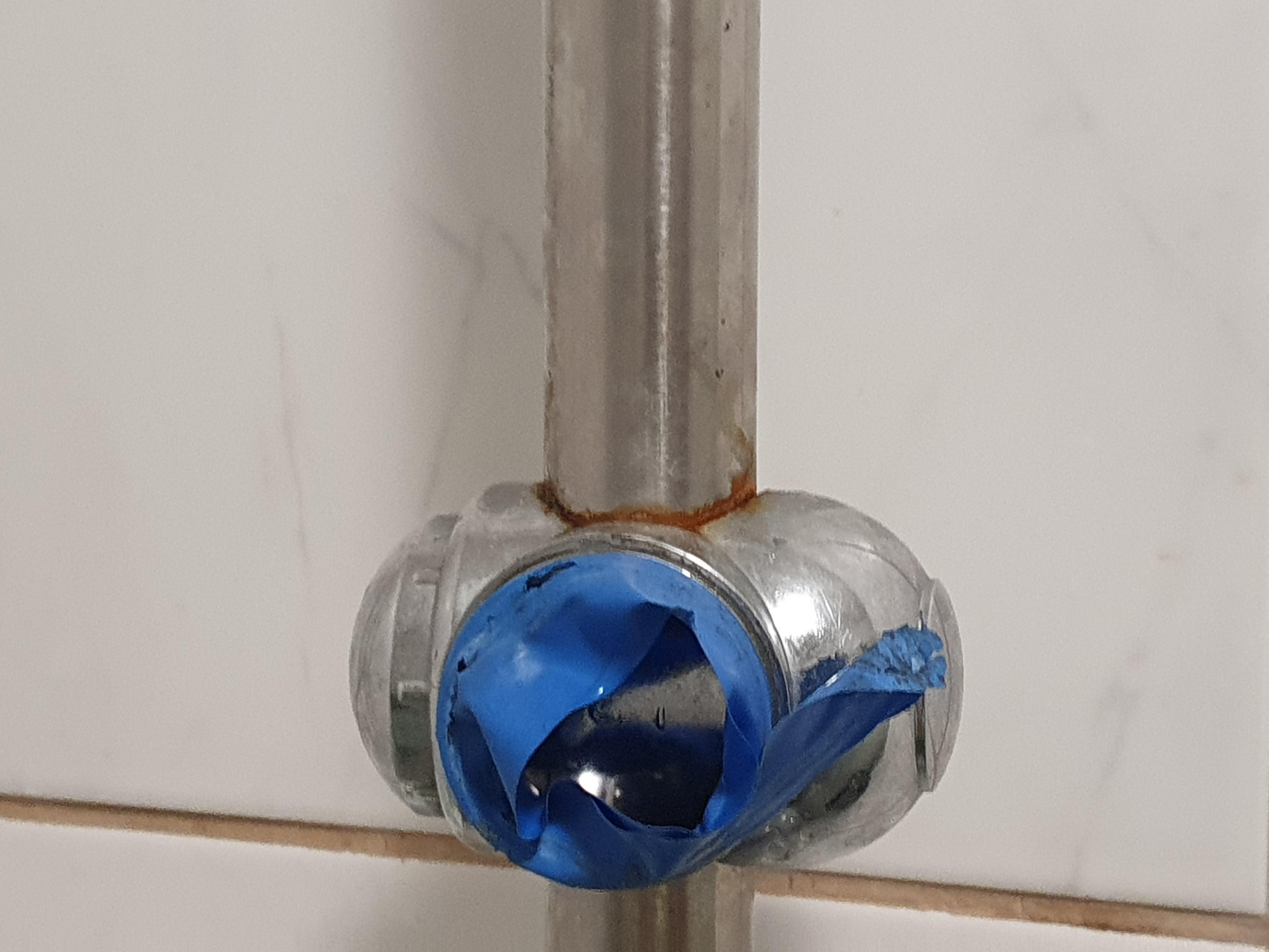 shower cabin: brown rust and fungus with blue tape as quick-fix for broken shower handle