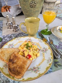 Scrambled eggs with cheese, 3 colored peppers, and scallions with toasted bread. Absolutely mouthwatering!