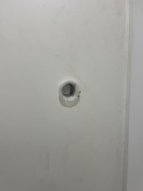 Hole in bathroom wall