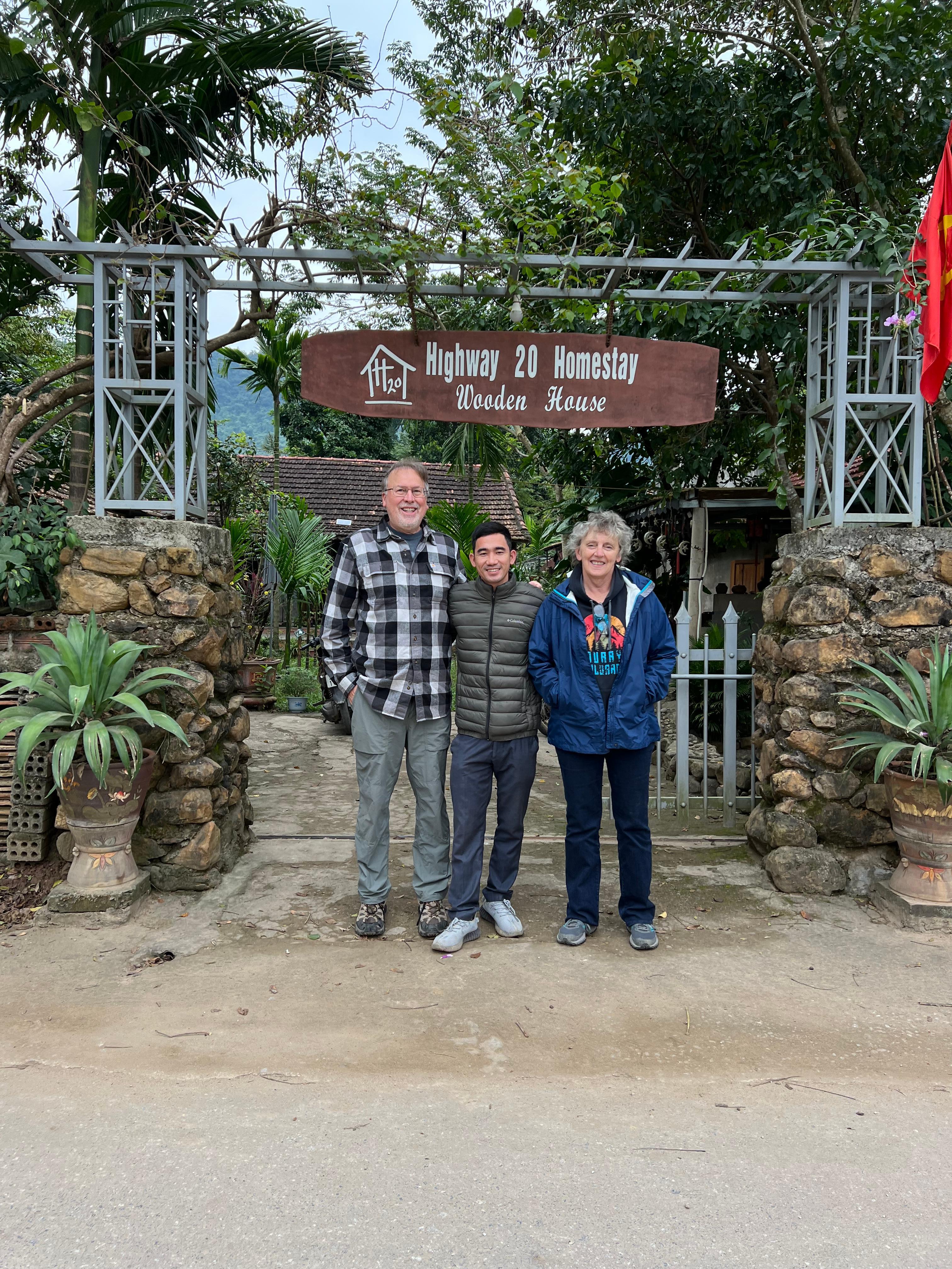 My wife and I with Binh at front gate 