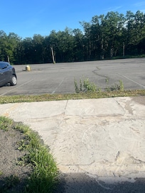 Dirty abandoned looking lot 2 to 4 cars park out at most