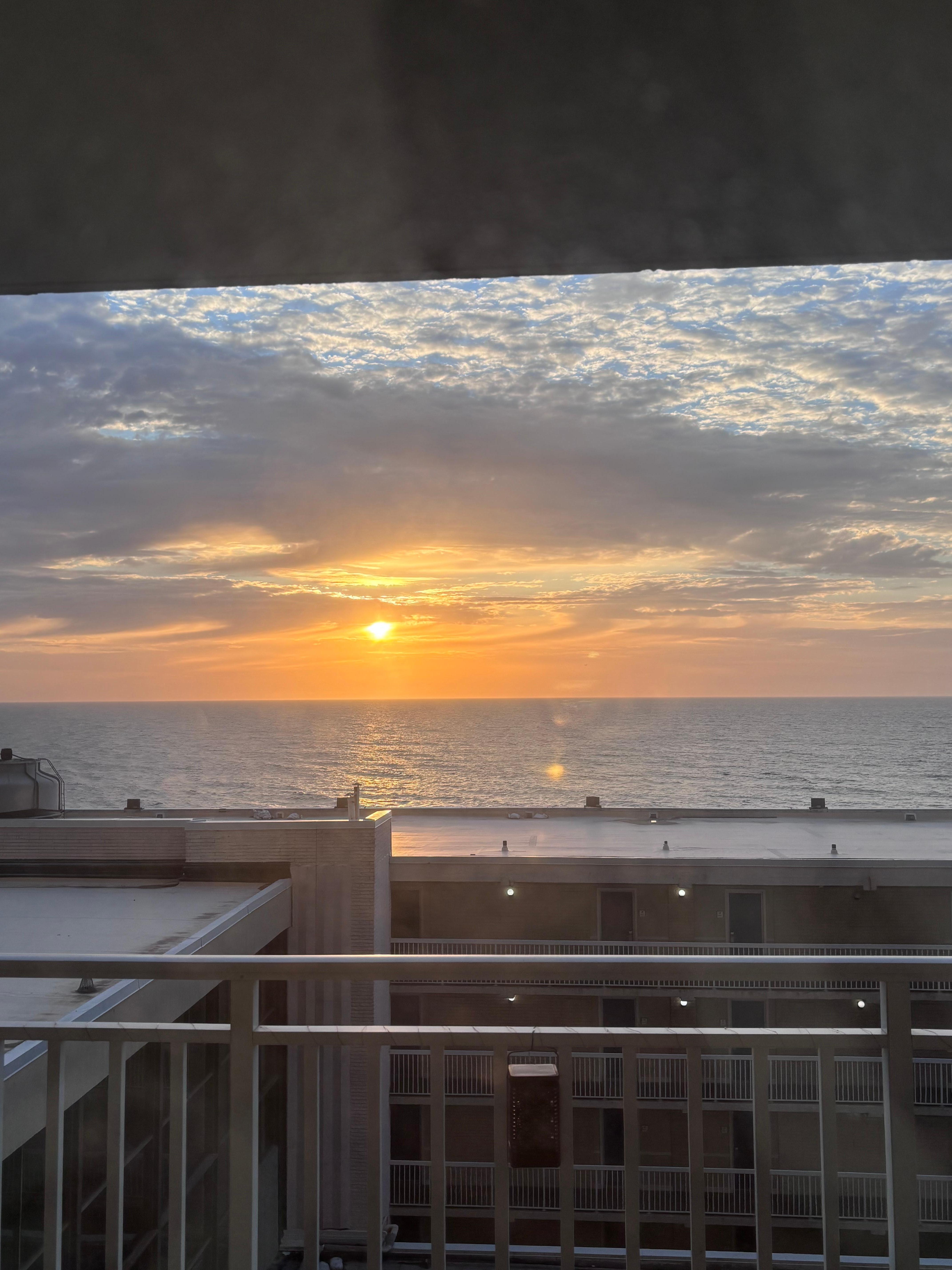 Ocean sunrise from balcony door. 