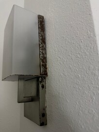 The metal fixtures are rusted and painted over.