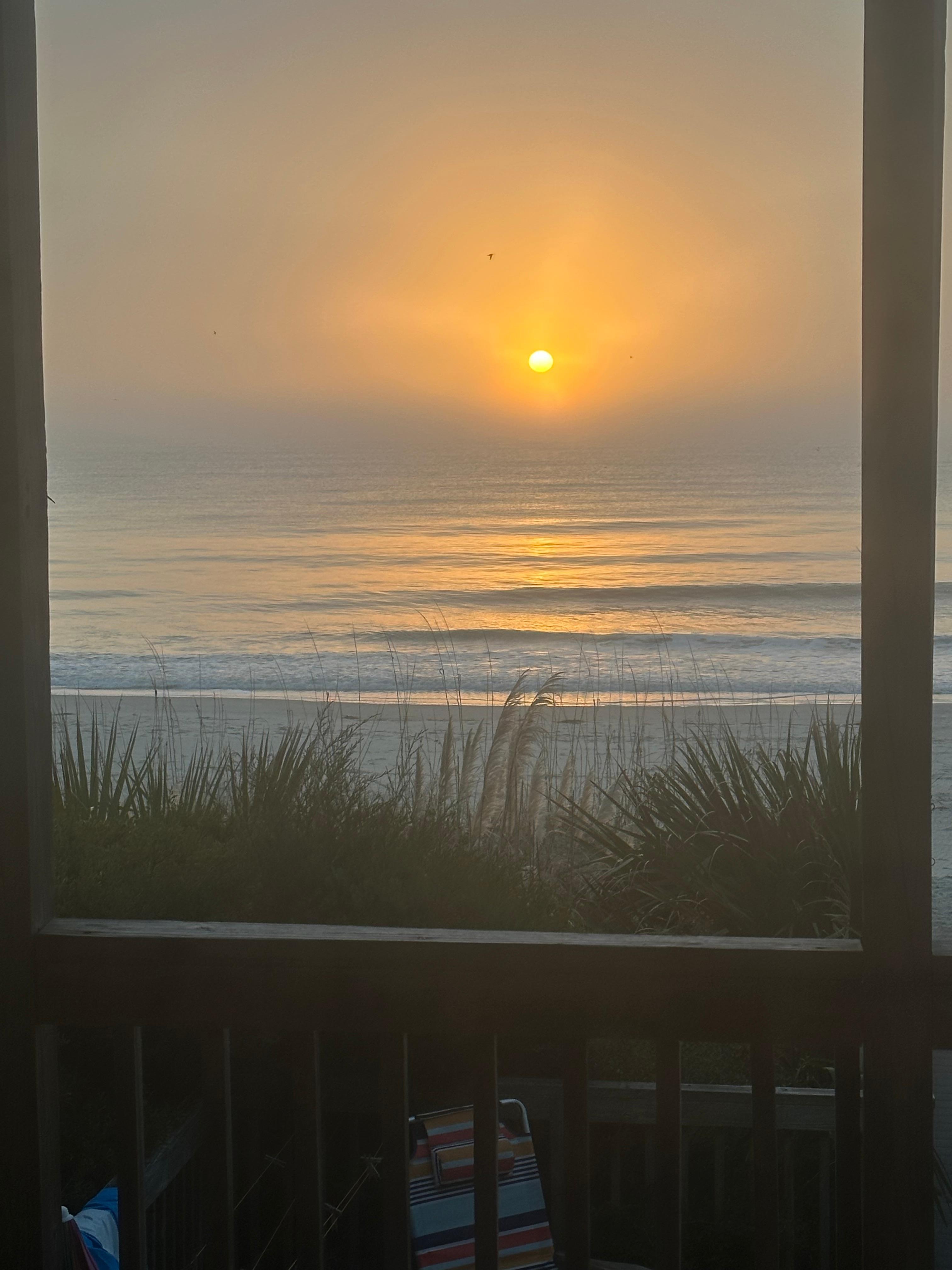 Sunrise over the ocean taken off of large porch.