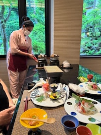 Server preparing rice dish at dinner