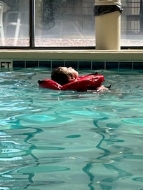 Maddie lounging in the pool.