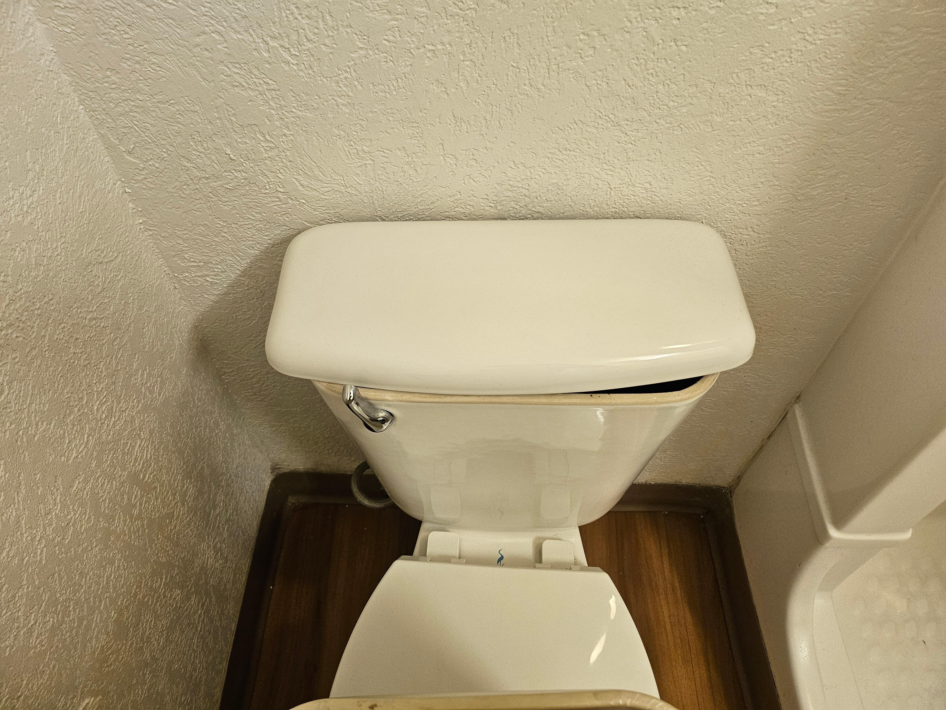 The toilet's water tank's cover is not matching.