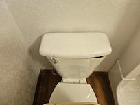 The toilet's water tank's cover is not matching.