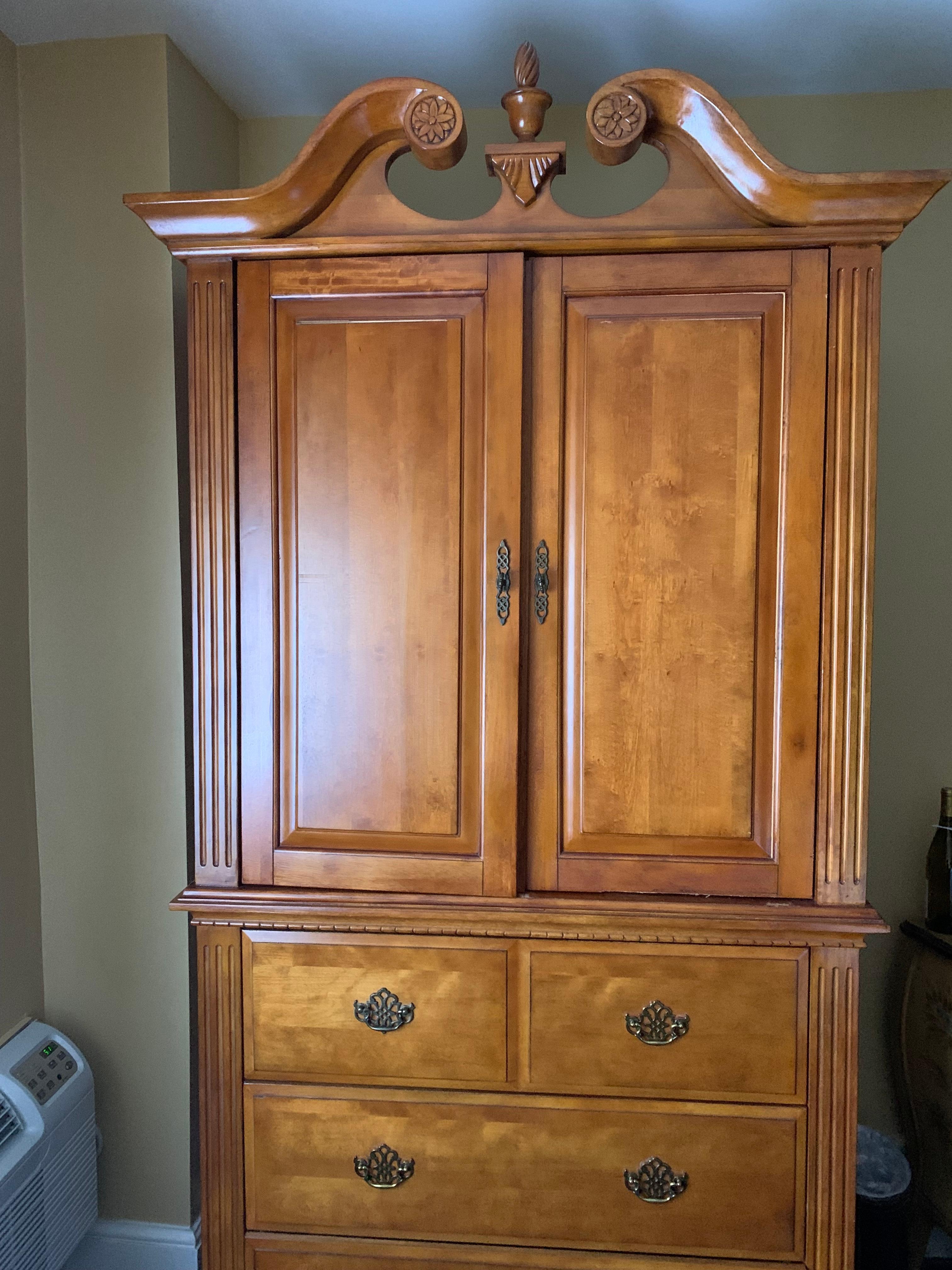 Cabinet offset to the right with a tv inside. Not sure why this wouldn’t be directly across from the bed instead of in the corner?