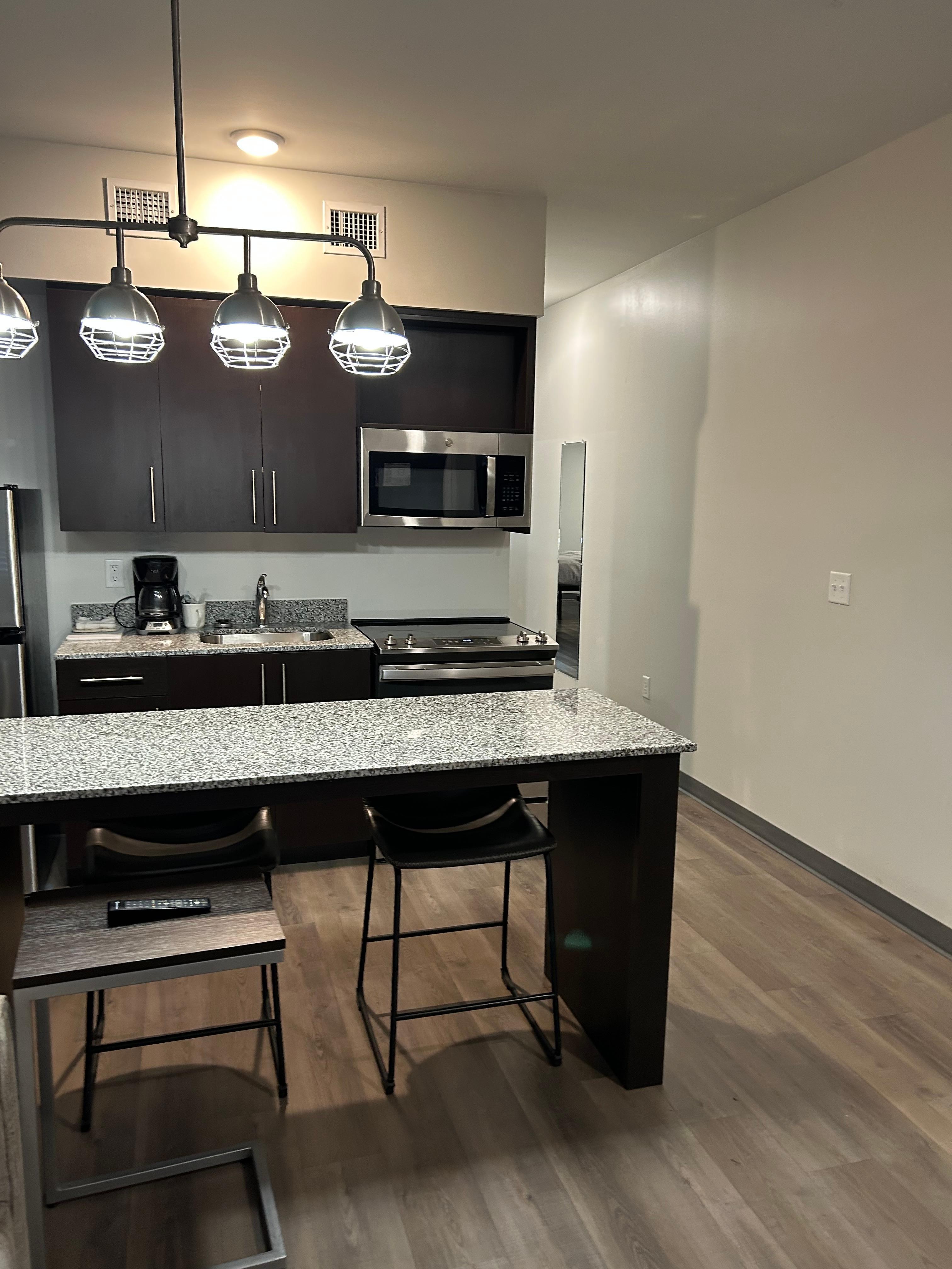 A really nice kitchen with plates , pots and utensils 