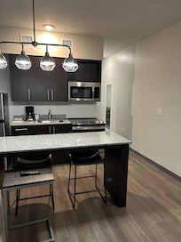 A really nice kitchen with plates , pots and utensils