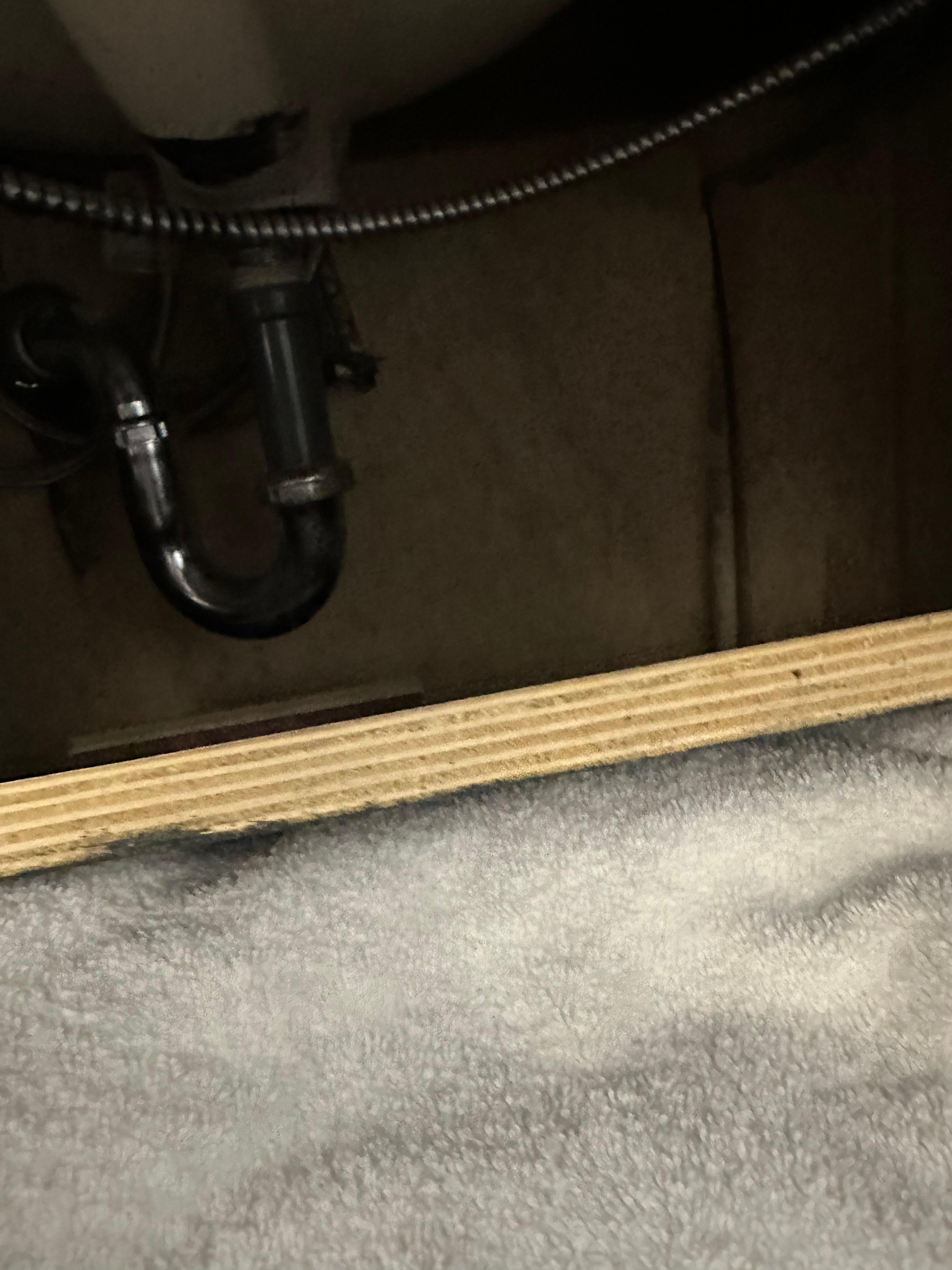 Under the sink where the towels were kept. Wood not secured 