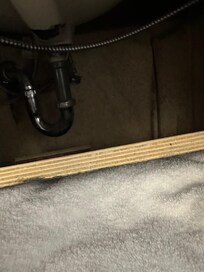 Under the sink where the towels were kept. Wood not secured