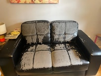 sofa that was covered by knitted blanket