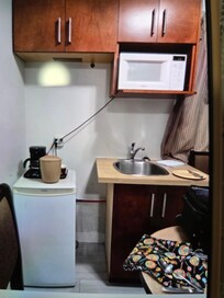 Dishes were in top left cupboard. I used chair to open microwave