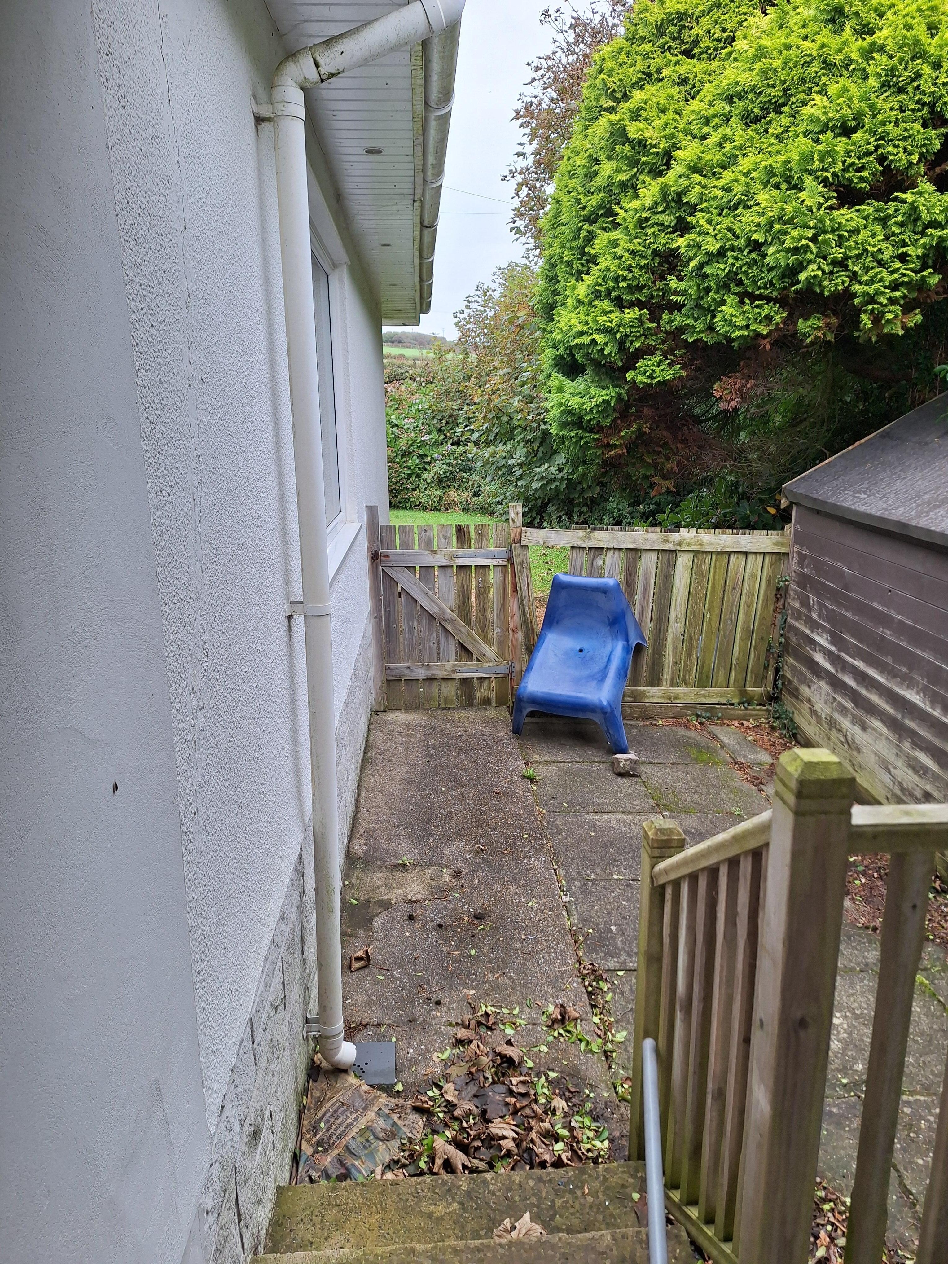 Plastic chair plugging hole in fence