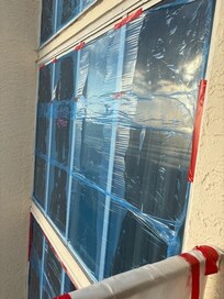 All windows taped with plastic
