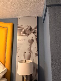 The use of tall prints helps overlook popcorn walls and ceiling