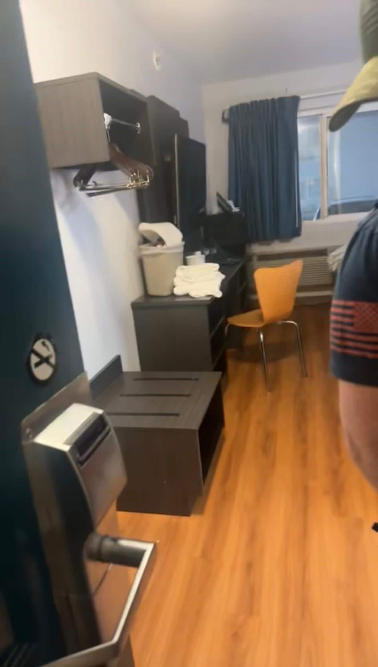 Trash and bedding/towels piled on the desk