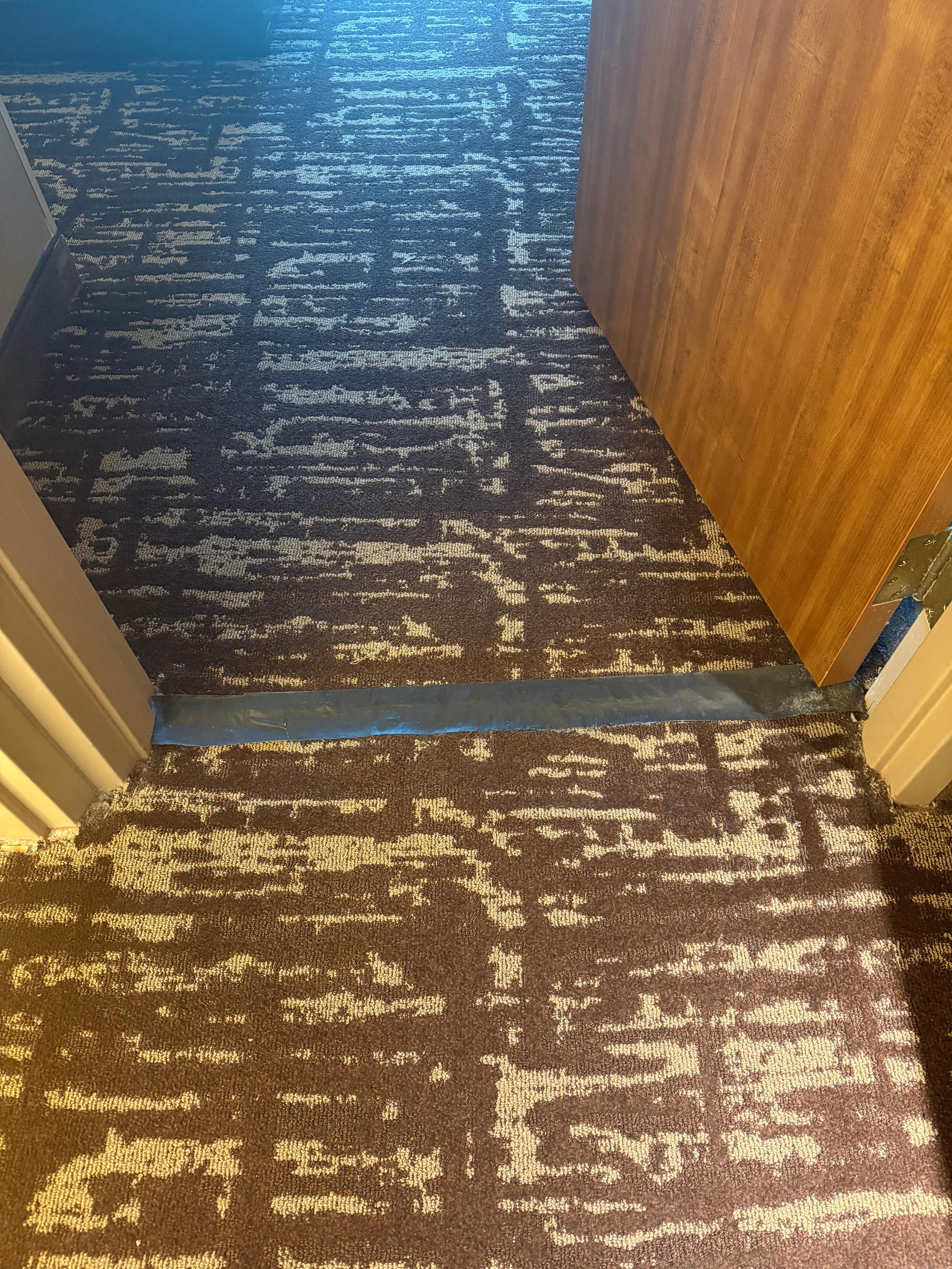 Tape to cover a hole in the carpet.