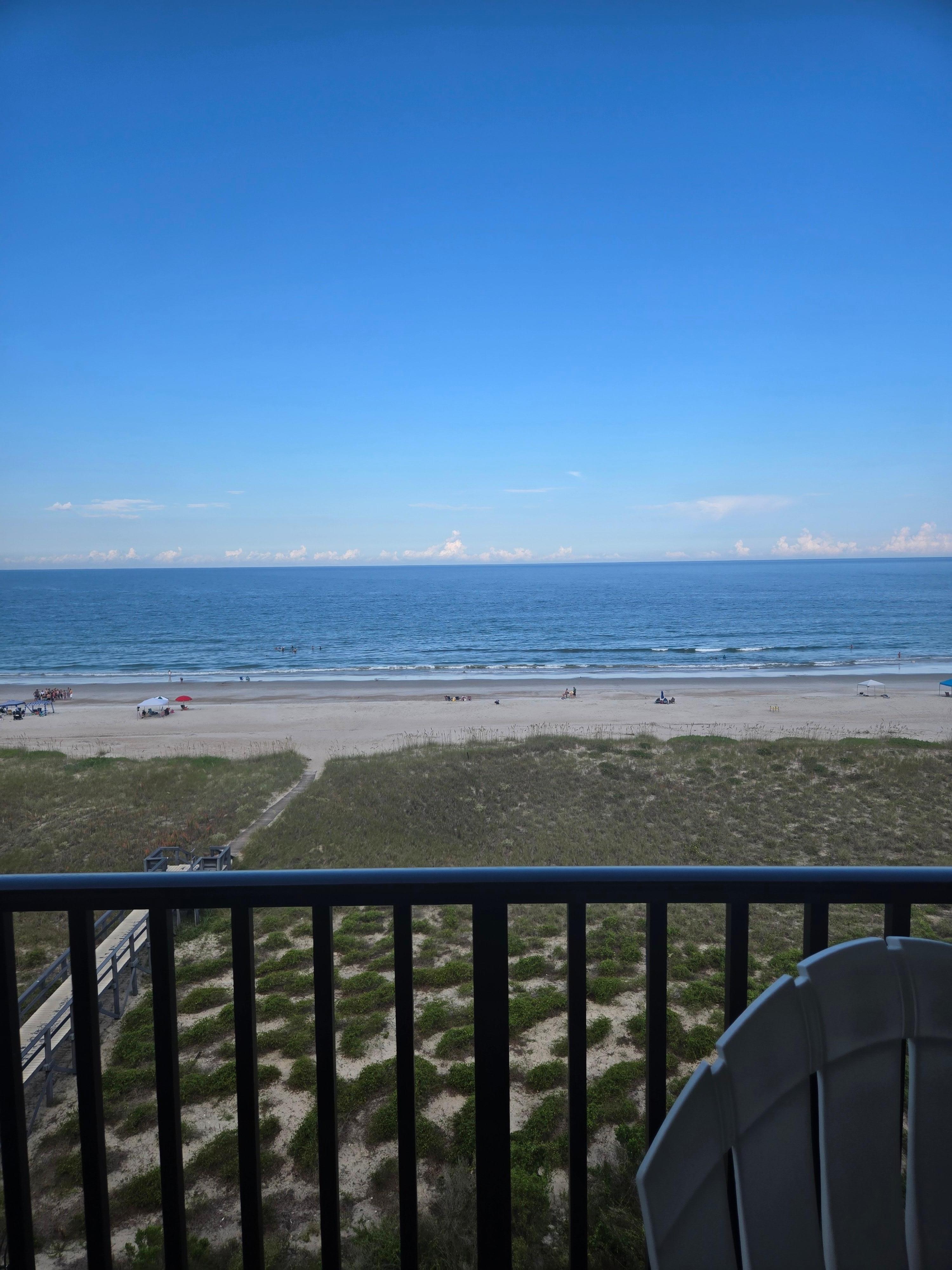 Of the balcony looking at the beach at the boardwalk to the beach. 