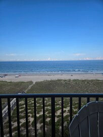Of the balcony looking at the beach at the boardwalk to the beach.