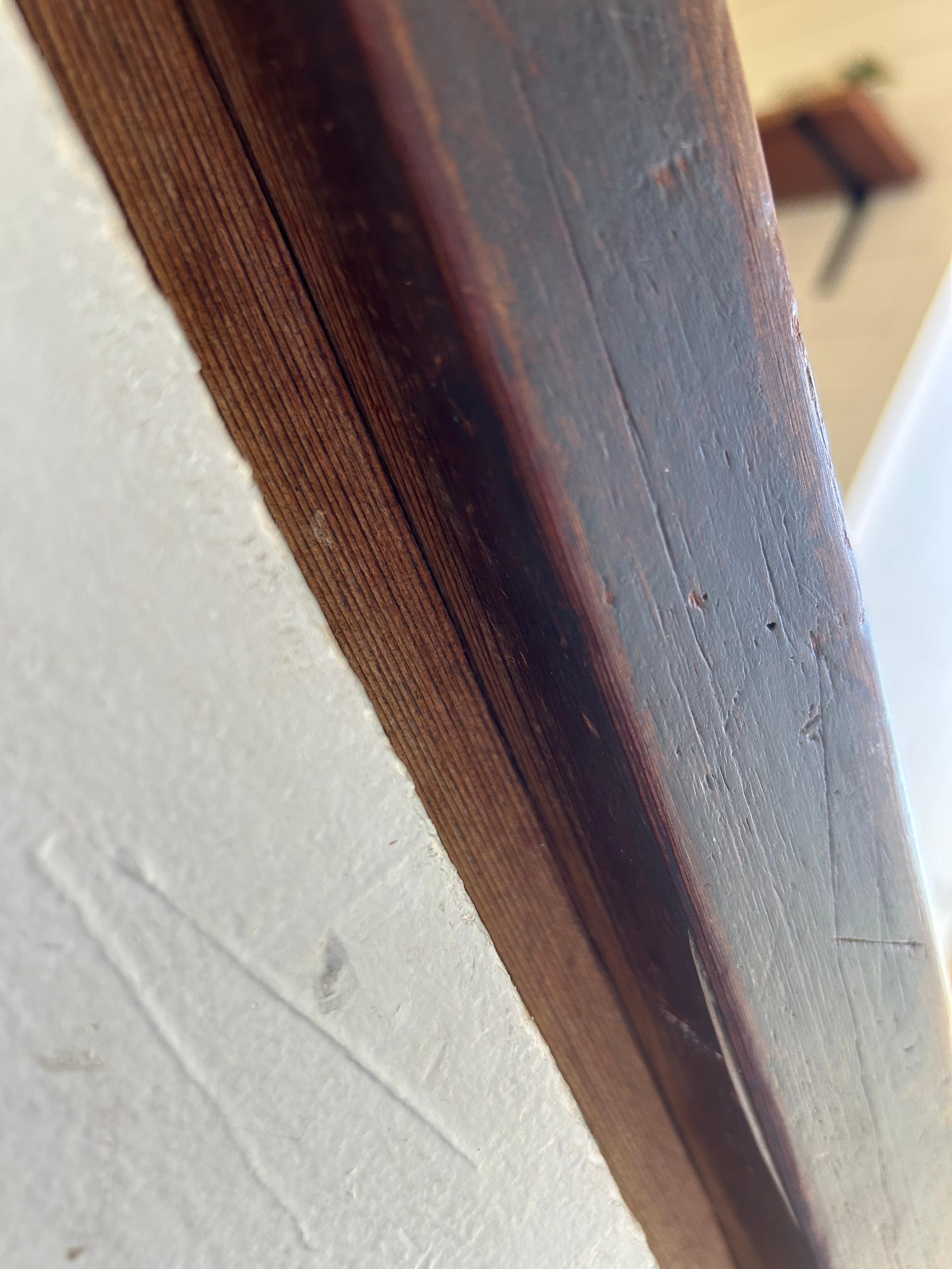 Unfinished wood under railing