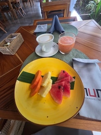 Every breakfast order comes with a plate of delicious tropical fruit
