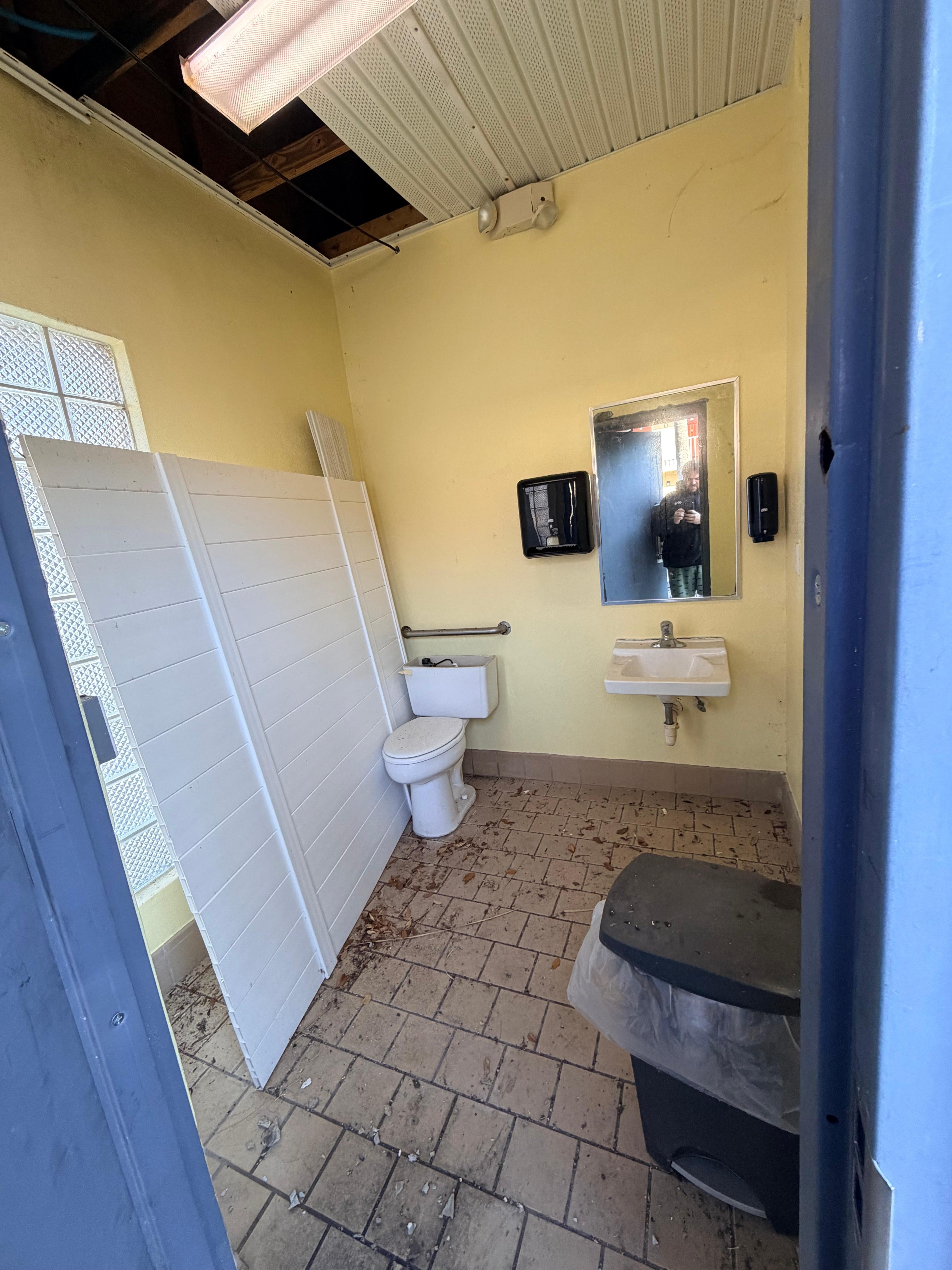 Outside bathroom. Roof falling in and gross