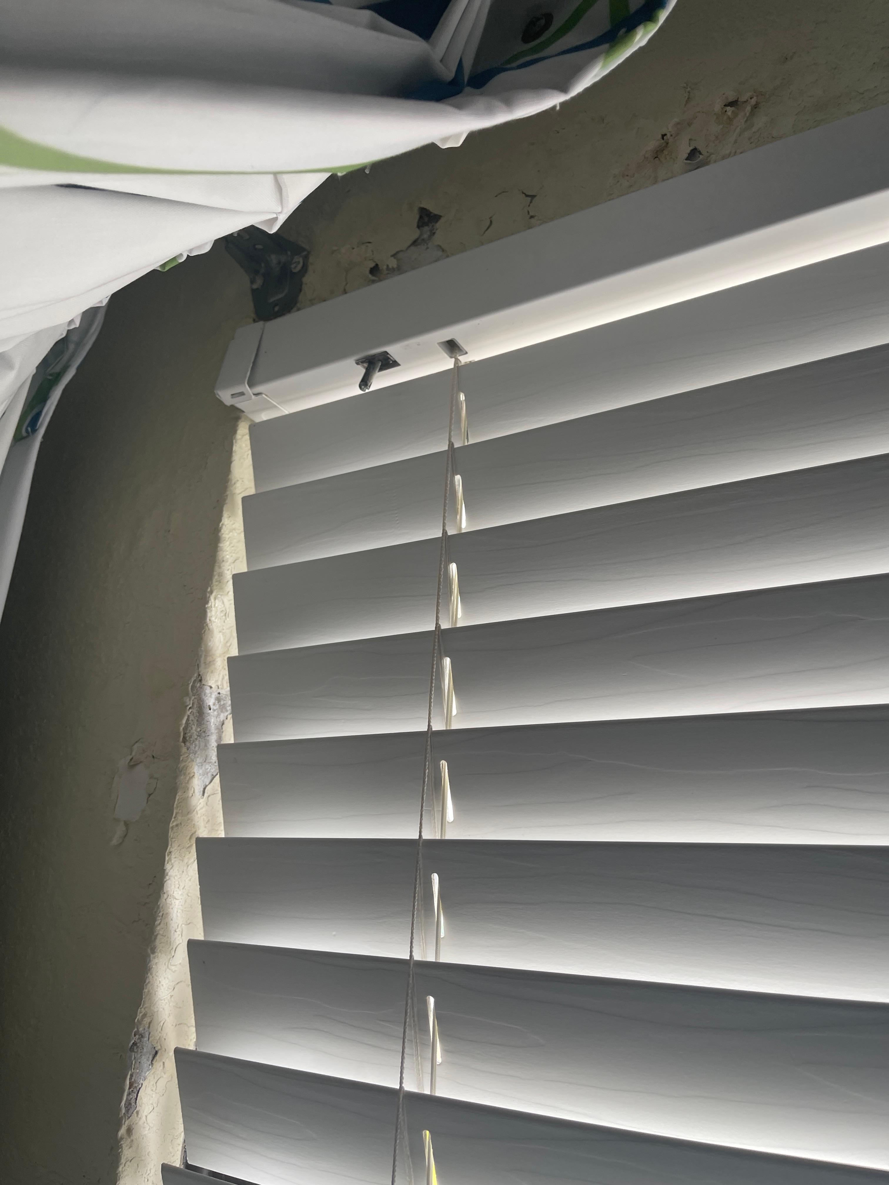 Broken blinds and peeling wall finish