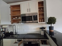 OH! And the kitchen has pans, pots, baking trays, muffin tins, cutlery, spoons, LITERALLY YOU NAME IT! There's even a hand mixer!!