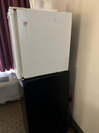 2 mini fridges stacked up on each other 1 not plugged up