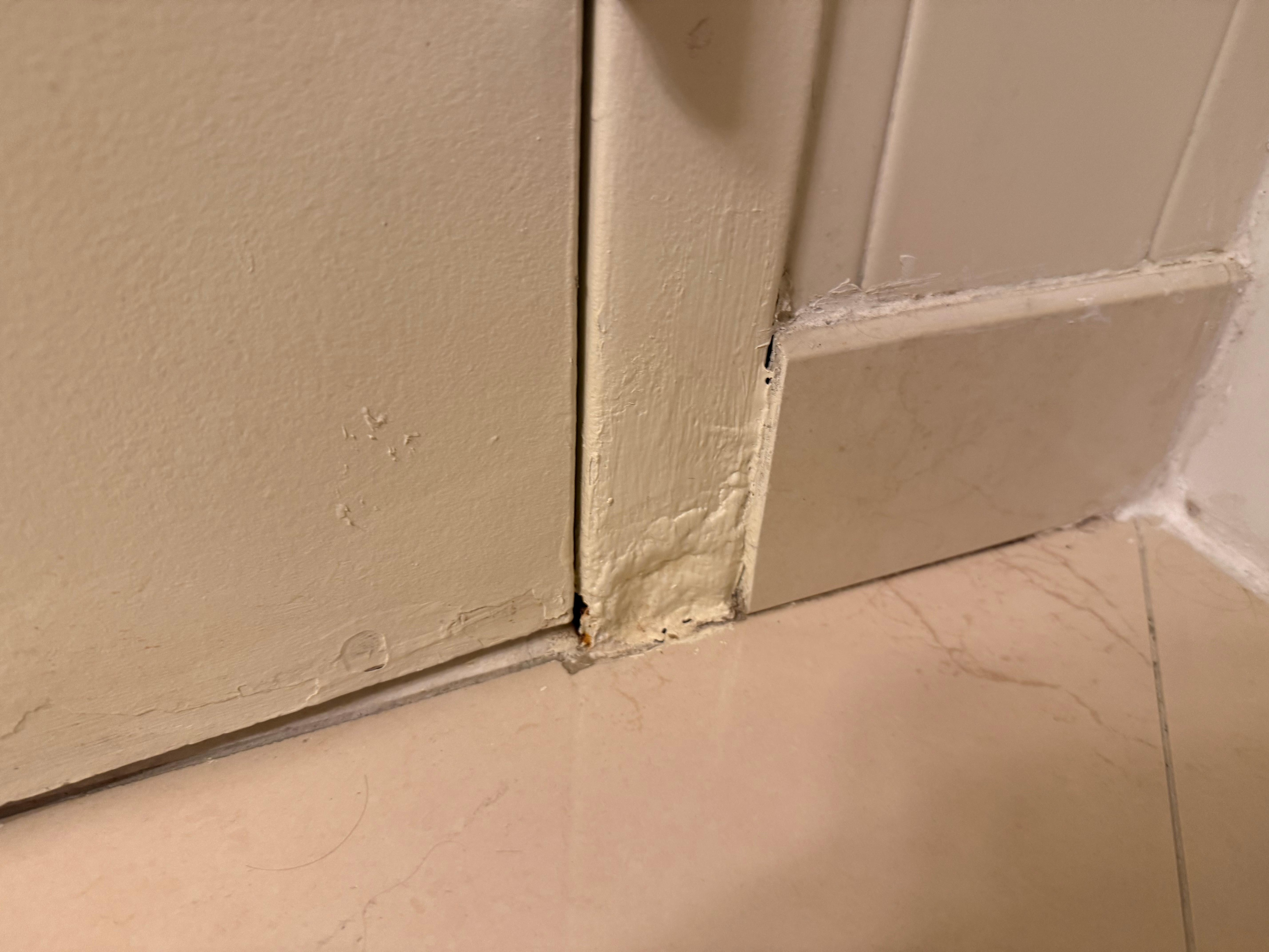 Bathroom missing part of the door but they caulked over and painted