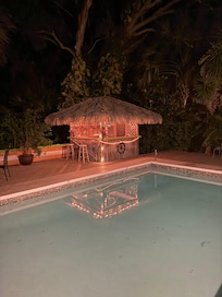 Tiki bar with small fridge inside