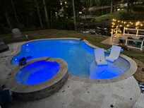 Beautiful pool and hot tub, plus lighted deck with fire pit.