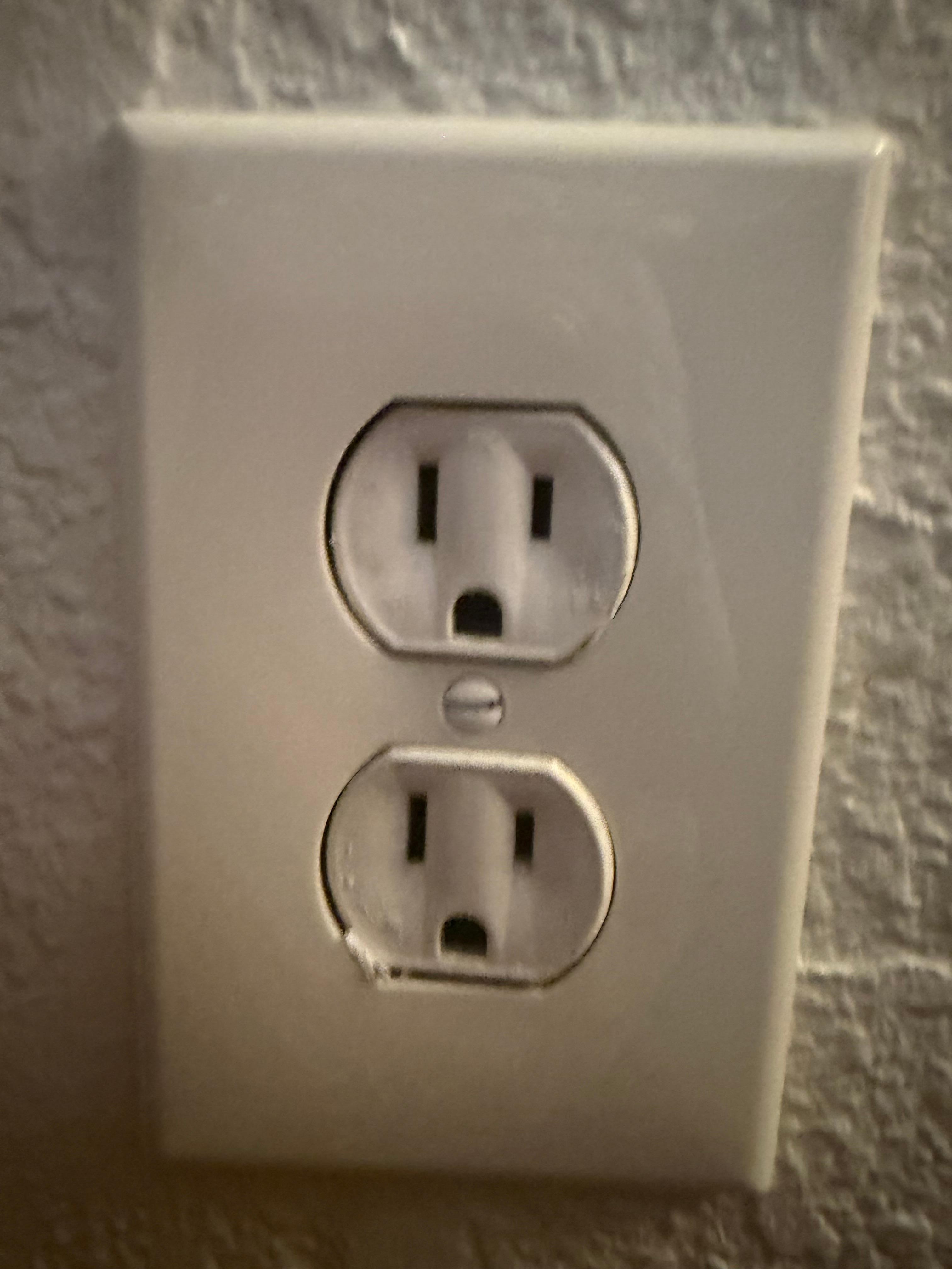 Painted unsafe electrical outlet that shot out yellow/orange light when tried to use. 