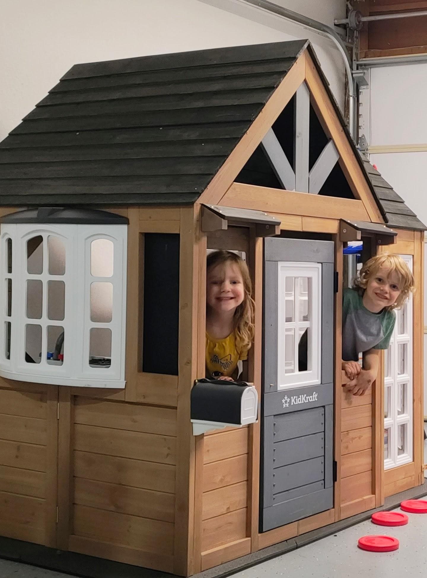 Two little ones in the playhouse.