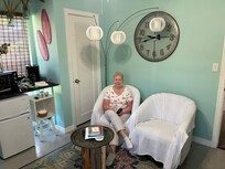 the sitting room with TV, refrigerator and microwave