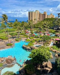 Main pool with slide and grottoes as seen from the balcony